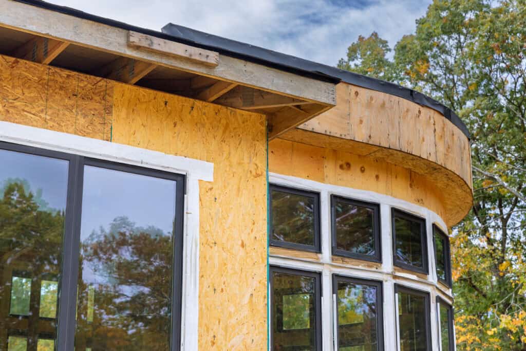 Contemporary house with large windows and curved design elements.